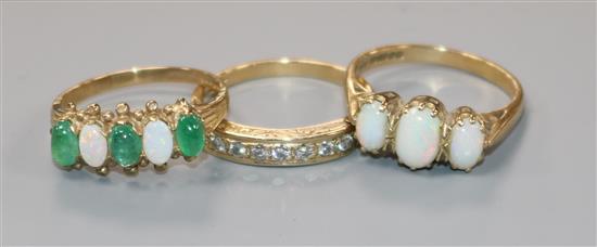 A 9ct gold cabochon emerald and opal five-stone half-hoop ring and two other 9ct gold rings,